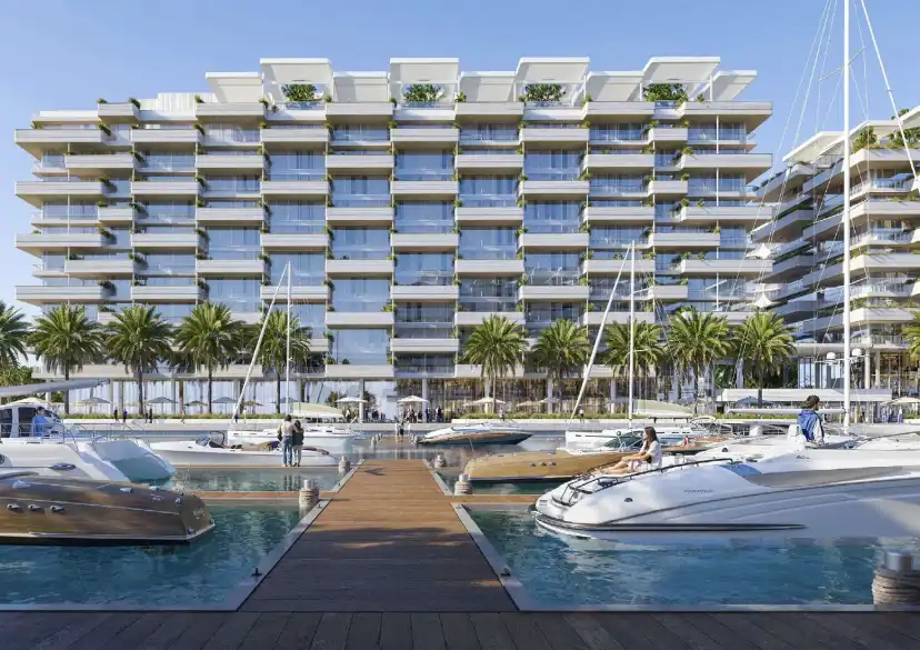 Marina residences seen from a timber jetty with yachts moored in front