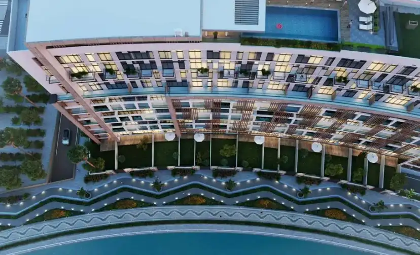 Aerial view of the building with terraces and a pool at dusk