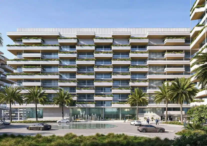 Residential building facade above a podium pool with palm trees