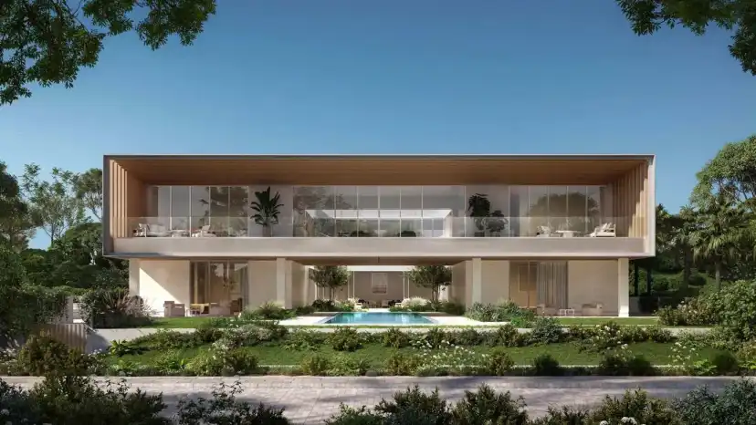 Villa with a timber-clad upper floor and a pool terrace in a landscaped garden