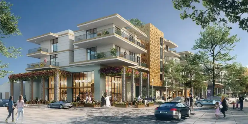 Residential building with cafes and shops at its foot, in the afternoon sun