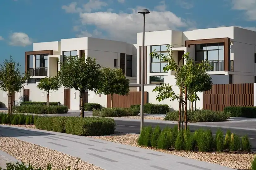 Villa with timber balcony screens and a landscaped path