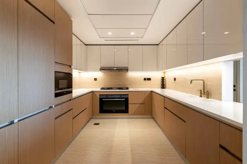 Fitted kitchen with timber cabinets and built-in appliances