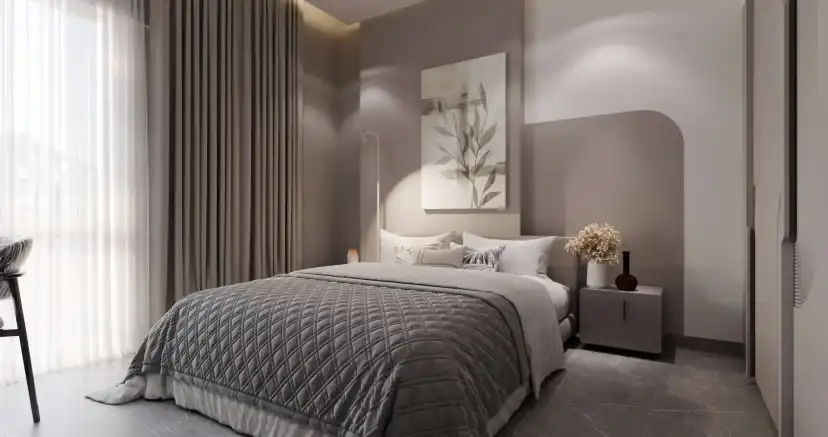 Bedroom with a quilted bedspread, a framed print and long curtains