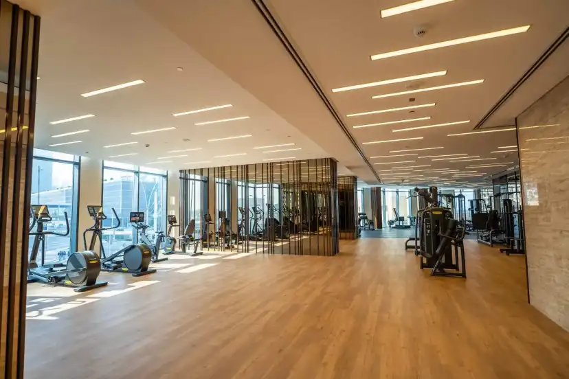 Gym hall with exercise equipment and timber flooring