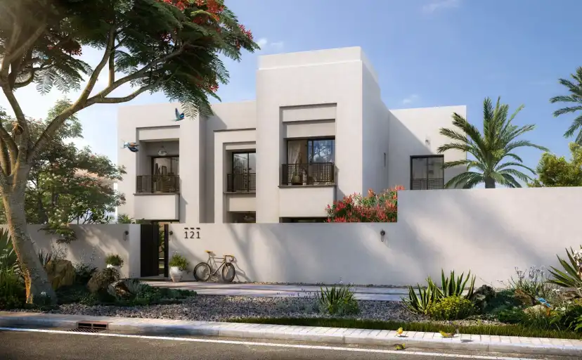 White cubic villa with a garden frontage and a bicycle at the gate