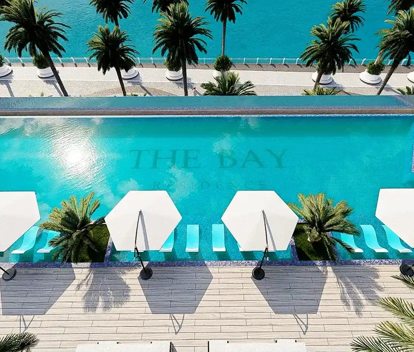 Pool deck with sunbeds and palm trees