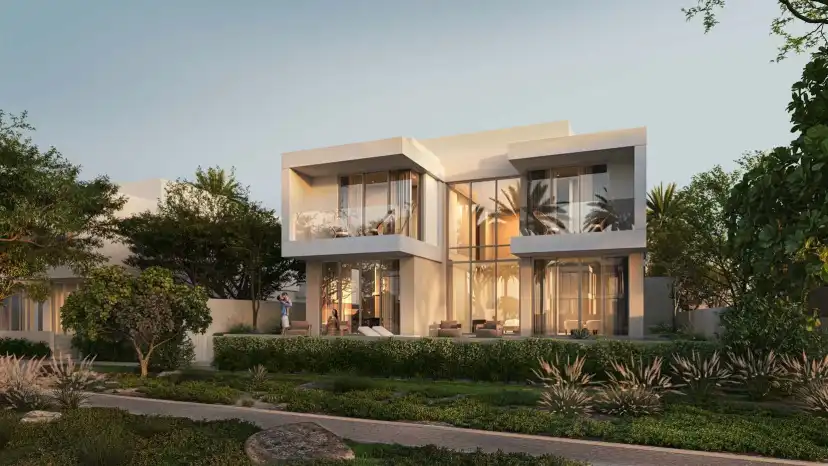 Double Height villa with a lit living room and a pool at sunset