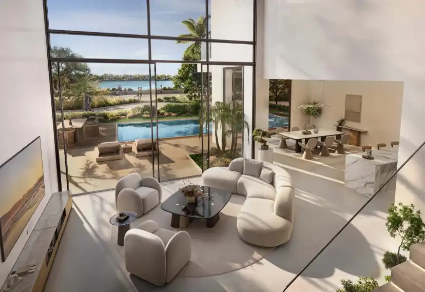 Double-height living room of a Gemini villa with lagoon views and a pool terrace
