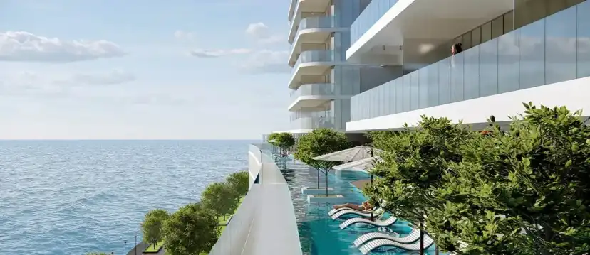 Pool terrace along the edge of the podium with sun loungers above the sea