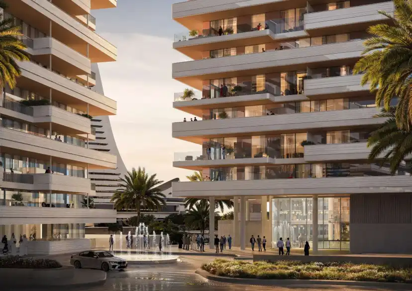 Entrance plaza between two terraced residential buildings with a water feature