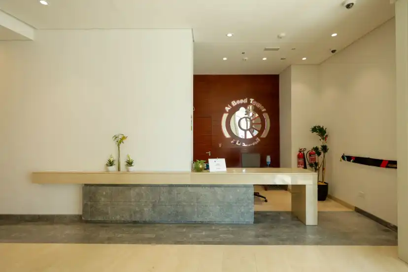 Reception area with a stone clad desk and a feature wall