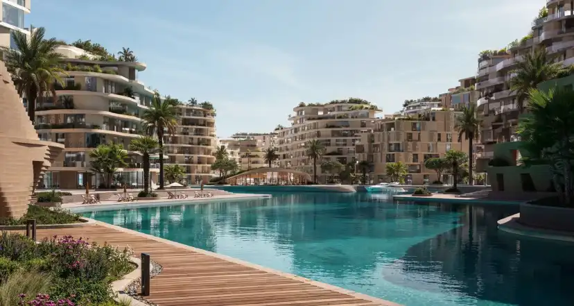 Lagoon pool with a timber deck and terraced buildings