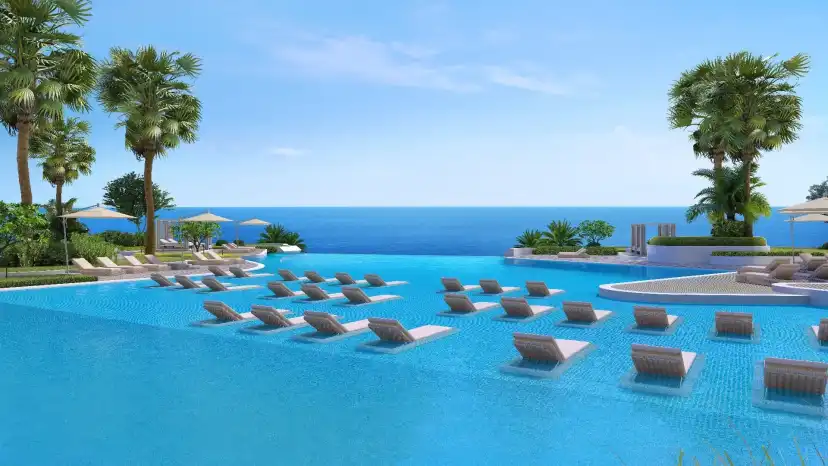 Lagoon pool with sun loungers facing the sea