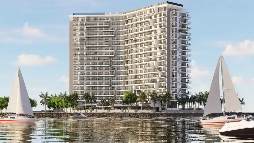The Icon Tower seen from the water with sailing boats