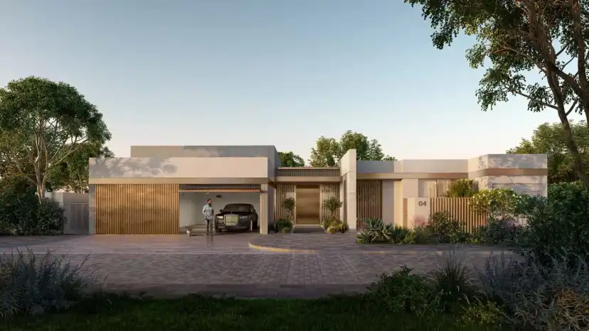 Single-storey entrance side of a villa with a garage at sunset