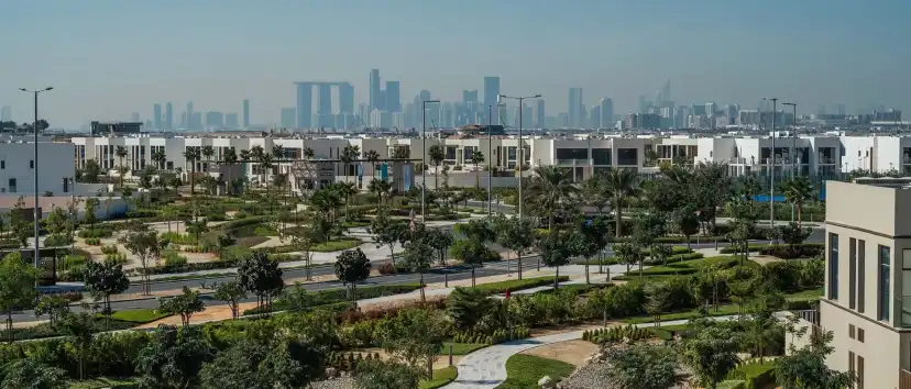 Villas and landscaped parkland with the Abu Dhabi skyline in the distance
