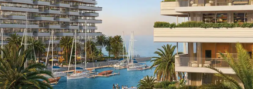 Residential tower beside the marina with sailing boats and palm trees