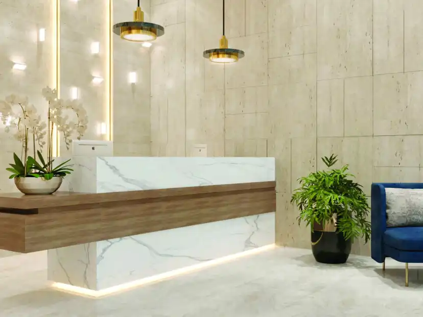Reception lobby with a white marble desk, a timber front and a blue armchair