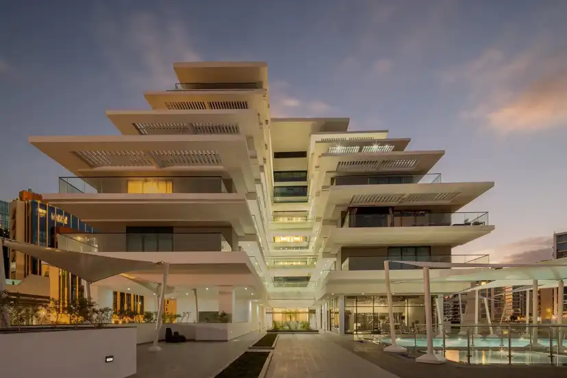 Stepped terraces lit at dusk above the entrance court