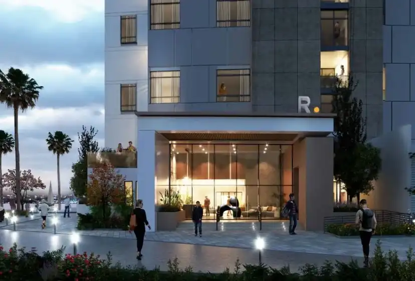 Building entrance at night with a lit glass lobby