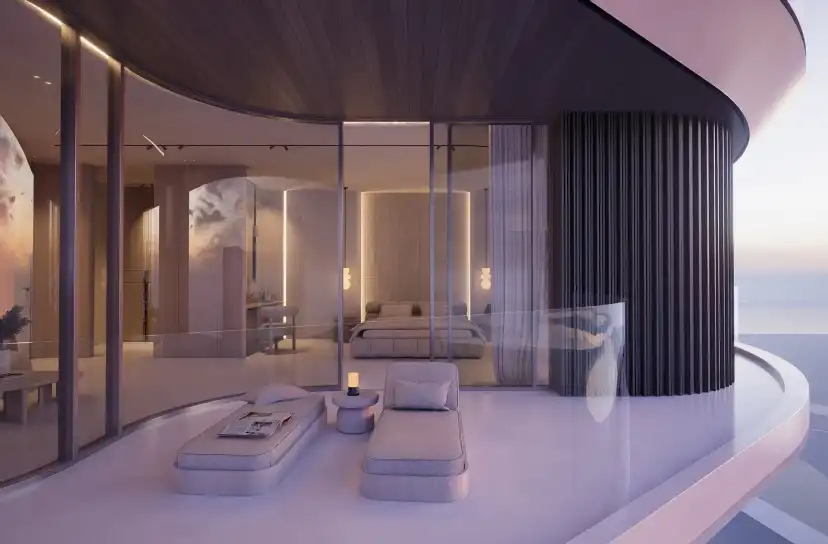 Penthouse terrace with lounge seating behind a curved glass balustrade at dusk