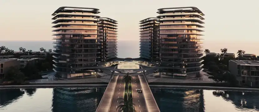 Two towers framing a pool avenue at sunset