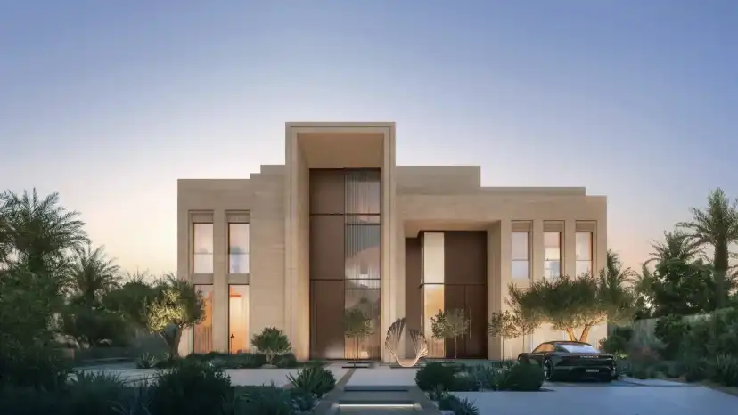 Mansion with a stone facade and a tall timber entrance door at dusk