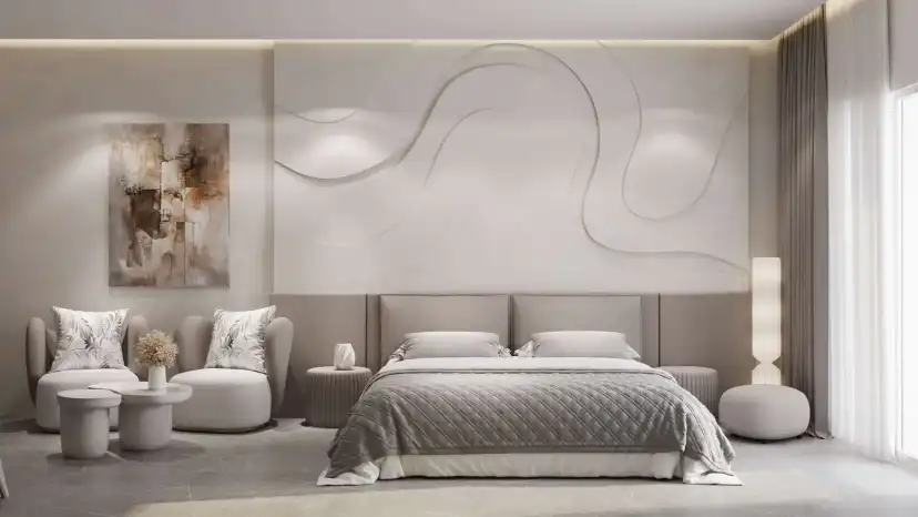 Bedroom with a sculpted wall panel behind the bed and two armchairs