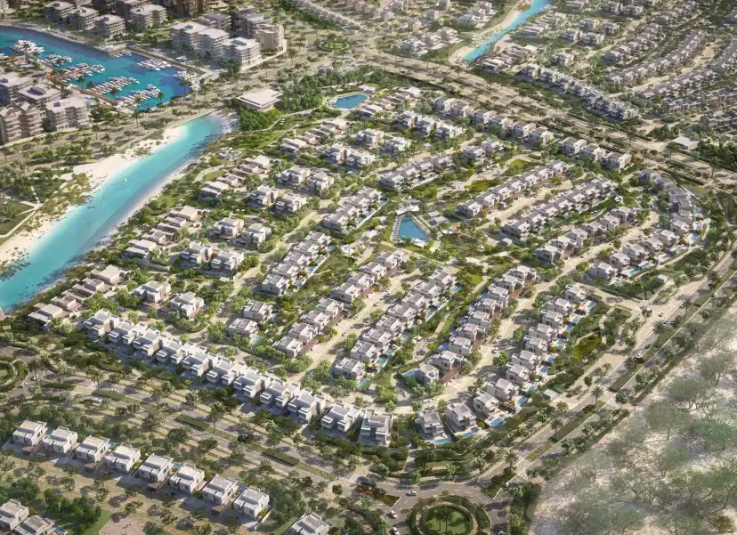 Aerial view of a Bayn villa neighbourhood with a waterway and the beach
