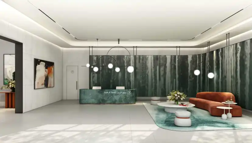 Residential lobby with a green marble feature wall and a reception desk